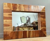 A rectangular hall mirror in rustic style, with a stainted striped wooden frame, with central