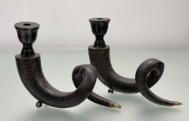 A pair of parcel-gilt patinated metal horn-form candlesticks, raised on ball feet. 25cm by 30cm.
