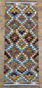 A hand-knotted Chobi kilim runner, central panel with repeating geometric motifs, vibrant multi-