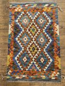 A hand-knotted Chobi kilim rug, central panel with repeating diamond-shaped medallions, ivory ground