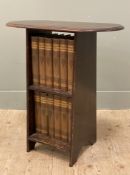 An early 20th century oak side table, fitted with twelve volumes of The Universal Encyclopedia, oval