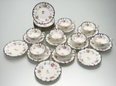 A Cauldon part tea service decorated with rose sprays with a blue enamelled and gilt scrolling