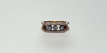 A modern 18ct rose gold ring of bar form set three brilliant cut diamonds, approximately 0.07ct each