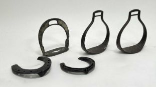 A collection of early riding stirrups and accessories comprising a pair of stirrups of circular