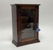 A Victorian mahogany table top display cabinet with hinged glazed door revealing two shelves, raised