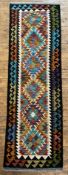 A hand-knotted Chobi kilim runner, central panel with six diamond medallions, multi-coloured
