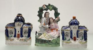 A collection of three Staffordshire flatback figures comprising, a pair of blue houses (a/f) (h-
