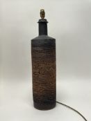A tall stoneware table lamp of bottle form, decorated with a relief-moulded finish with stylised