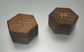 A pair of modern octagonal acacia wooden boxes with compass rose inlaid top and hinged lid revealing