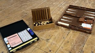 A collection of games comprising a vintage travel backgammon set within a folding faux-leather
