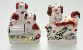A pair of Staffordshire Flatback figures, one of a Spaniel with bird of prey in mouth (