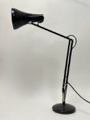 A large anglepoise desk light, raised on a circular base (h. 68cm)