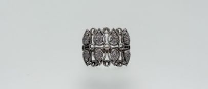 An Eastern white metal ring set two rows of four heart-shaped panels, set eight brilliant cut