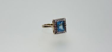 A 9k gold ring set cushion cut zircon approximately 1ct within a surround of twenty diamond points N