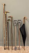 A collection of vintage walking sticks, including four horn-handled sticks, two shooting sticks