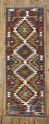 A hand-knotted Chobi kilim runner, central panel with four diamond motifs on a soft purple ground: