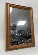 A contemporary wooden framed mirror panel. (h. 75.5cm)