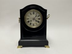 A French made black slate mantel clock with brass mounts, twin brass handles and bracket feet,