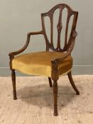 A mahogany Hepplewhite-style open armchair, shield-shaped back with carved splat details, with
