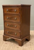 A reproduction mahogany chest of drawers, crossbanded top over four inlaid drawers, raised on