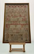 A framed Victorian Sampler with alphabet and numeral stitchwork in various coloured threads with box