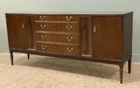 A 20th century oak sideboard, fitted with four graduated central drawers flanked by twin cupboard