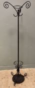 A modern wrought iron coat stand, with three scrolled hooks to top raised on tubular support,