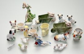 A collection of various animal figures comprising, a pair of pig figures smoking a pipe pushing a