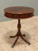 A reproduction mahogany drum table, circular top with three frieze drawers, raised on baluster