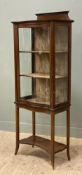 An Edwardian mahogany display cabinet, ledge top and serpentine front, with glazed front and sides