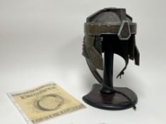 A Lord of the Rings limited edition reproduction helmet 'The Helm of Gimli', raised on a wooden