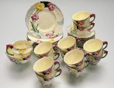 A Crown Staffordshire Art Deco part tea service in a floral pattern on yellow with moulded flower