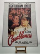 A framed Casablanca film poster with the cast of Humphrey Bogart, Ingrid Bergman and Paul Henreid