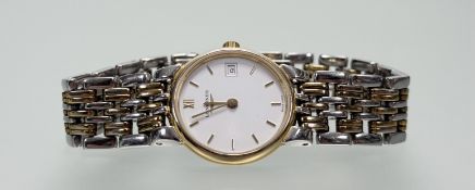 A modern Longines stainless steel and gilt metal quartz wristwatch with white enamel dial and