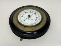 A Christie & Wilson of Glasgow brass ship's bulkhead aneroid barometer with brass mounts and