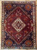 A hand-knotted Persian Qashqai rug, central medallion surrounded by stylized foliate and animal
