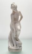 A 19thc School white marble sculpture of Venus after her bath, raised on circular base, unsigned. (