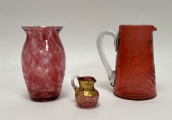 A cranberry glass jug with clear glass handle and etched fearn leaves 'Mrs T Mungall' inscribed to
