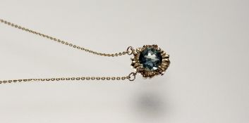A modern 9ct gold pendant set circualr facet cut zircon approximately 1ct on trace link chain with
