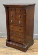 A reproduction mahogany Wellington chest of drawers, moulded top with four short over four long