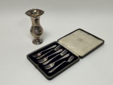 A George V London silver baluster bud vase with rose cast border on a circular weighted green felt