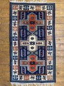 A hand-knotted Caucasian Kasak rug, central panel with three geometric medallions enclosed within