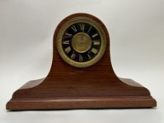 An early 20th Century Napoleon hat-style mantel clock, with gilt Roman numeral face and raised on