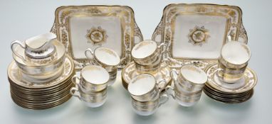 A Wedgwood Columbia Gold pattern part tea service comprising, a two sandwich plates (l-27cm), twelve