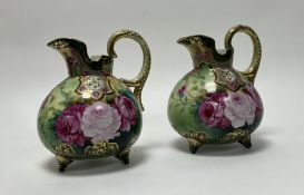 A pair of Japanese late 19th/early 20th Century Nippon-style pitchers decorated with gilt