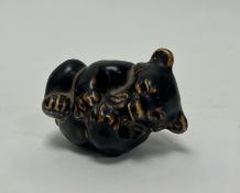 A Royal Copenhagen stoneware playing bear cub in a brown glaze wash, mid-20th Century, Knud Kyhn for
