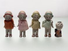 A collection four 1930's bisque porcelain doll figures,with hand-painted features each in a handmade