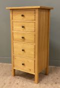 A modern oak chest of drawers, fitted with five graduated drawers and raised on square supports: