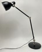 A modern Anglepoise table lamp in black, with chrome mounts and raised on a circular base (h.