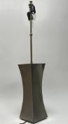 A tall contemporary metal table lamp of asymetrical form with brass stem, lacking shade (h. 91cm)